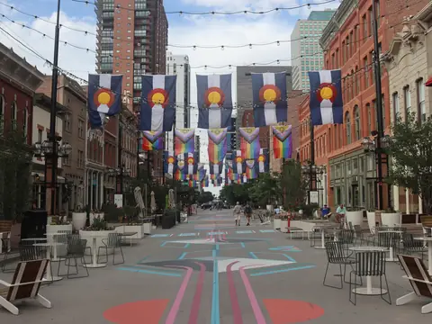 Larimer Square in downtown Denver under rows of Colorado flags