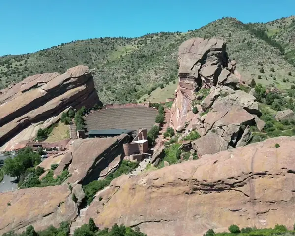 Red Rocks and the foothills of the Front Range west of Denver under a bright blue sky