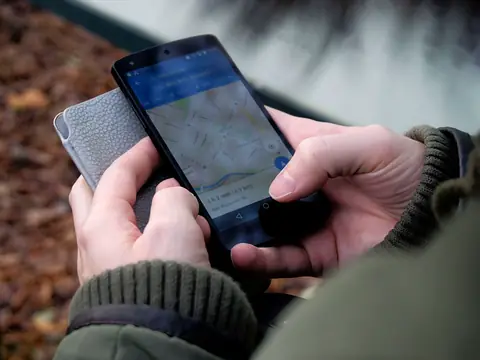 Hands using a map app on a phone outdoors
