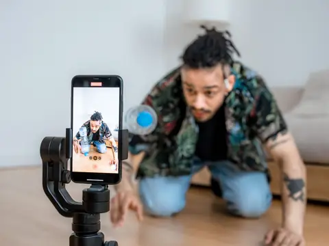 A creator filming a short video on a phone gimbal