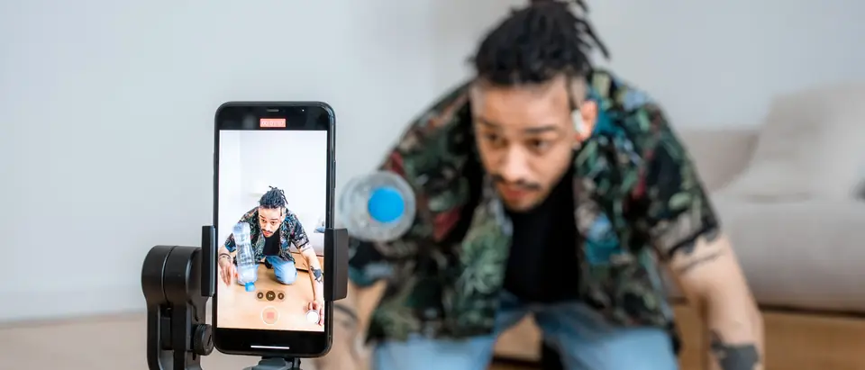 A creator filming a short video on a phone gimbal