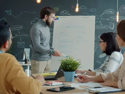A planner walking a small group through ideas at a whiteboard
